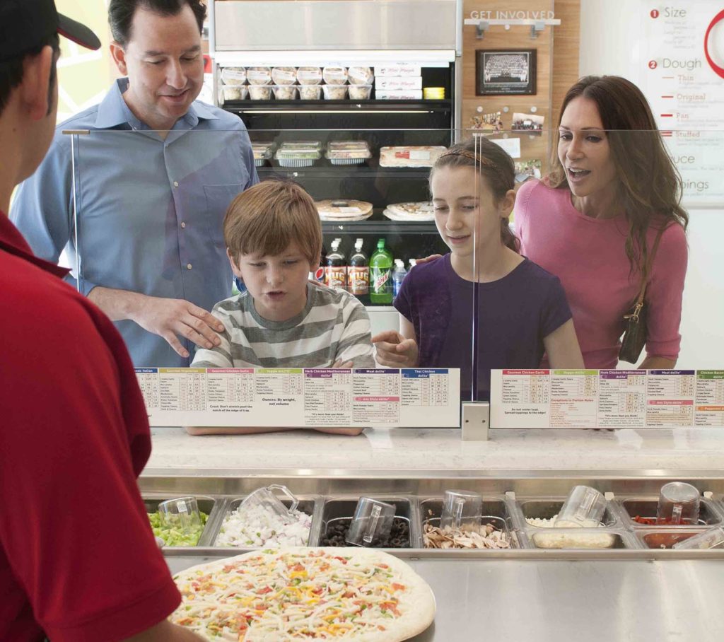Family ordering pizza in Papa Murphy’s restaurant